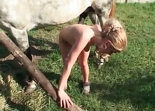 Blonde fucked from behind by horse