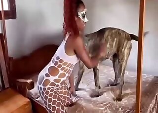 Redheaded and horny-looking gal takes dog cock