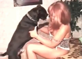 Naked whore is having some fun with a lovely black dog