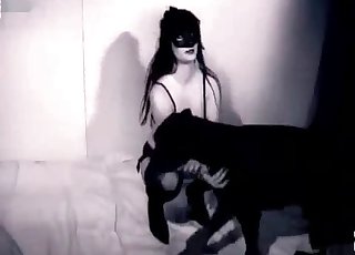 Stunning woman and a black dog are having sex together